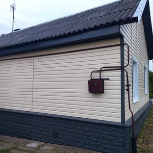 Монтаж фасада сайдингом Ю-пласт Корабельный брус Ванильный и монтаж цоколя сайдингом Стоун-хаус камень изумрудный